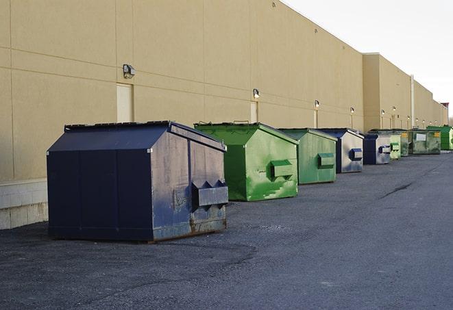 a row of heavy-duty dumpsters ready for use at a construction project in Dunkirk